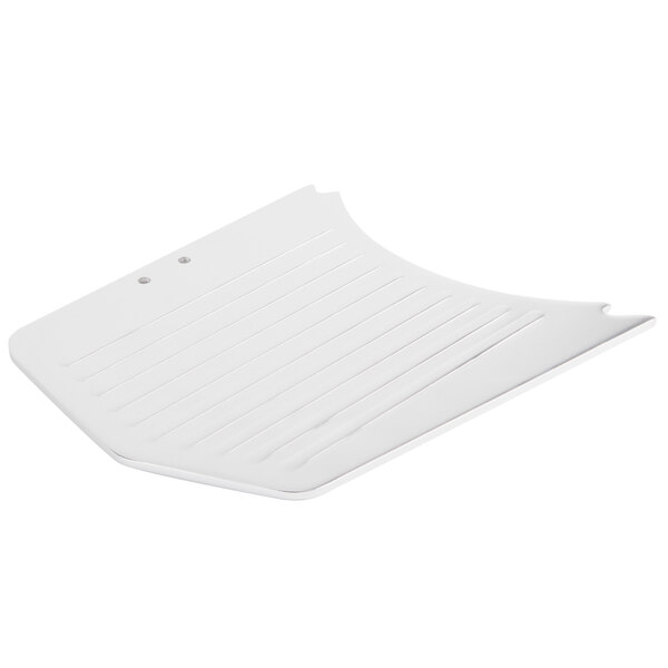 A white plastic object with lines and a broken edge.