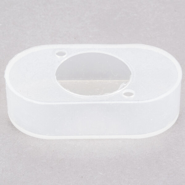 A white plastic switch cover with a hole in it.