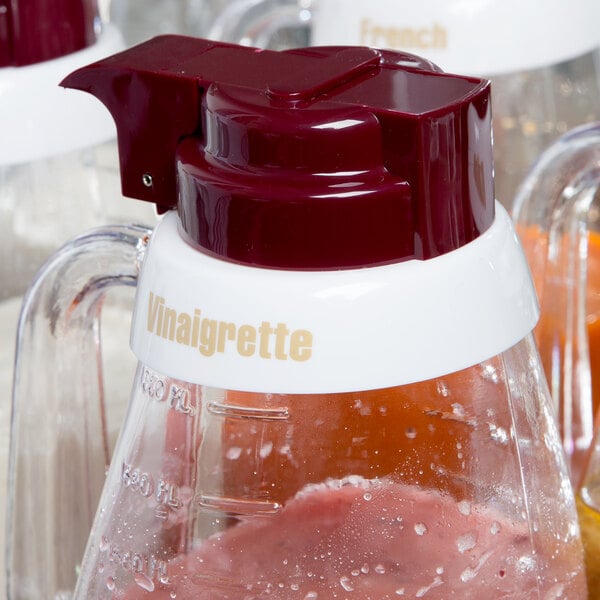 A Tablecraft salad dressing dispenser collar with beige lettering on a pitcher.