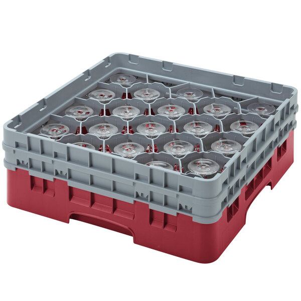 A red and grey plastic Cambro glass rack with clear glasses inside.