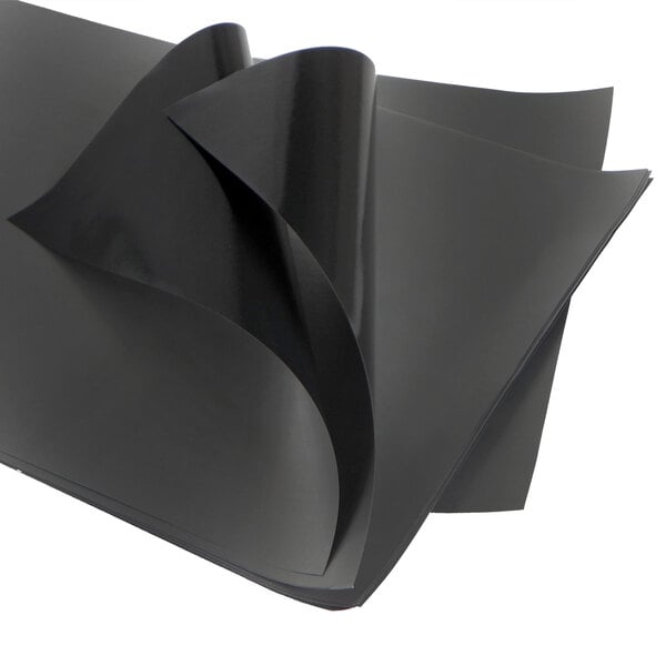 A stack of black PTFE non-stick release sheets with a folded edge.