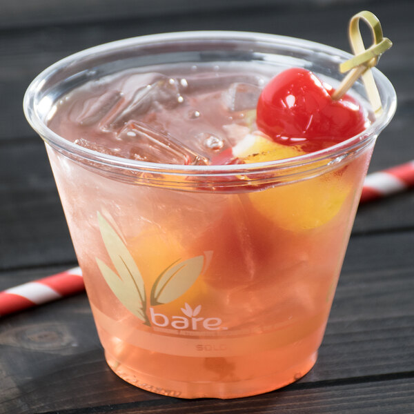 A Bare by Solo RPET disposable plastic cup filled with a drink and a cherry on top.