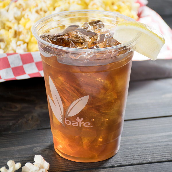 A Bare by Solo RPET disposable cup filled with iced tea and a lemon wedge.