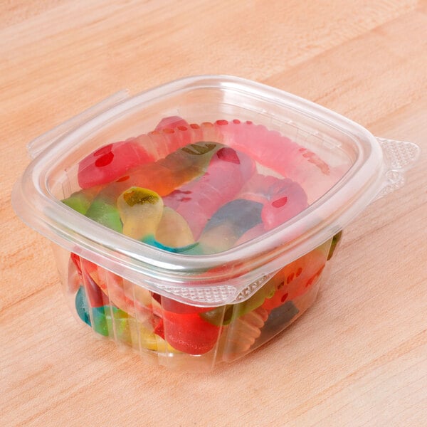 A Genpak clear plastic deli container filled with gummy worms.