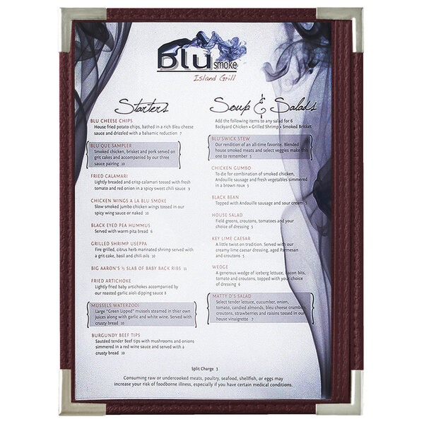 A Menu Solutions burgundy menu board with silver corners on a restaurant table.