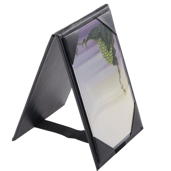 A black Menu Solutions table tent frame with picture corners holding a photo.
