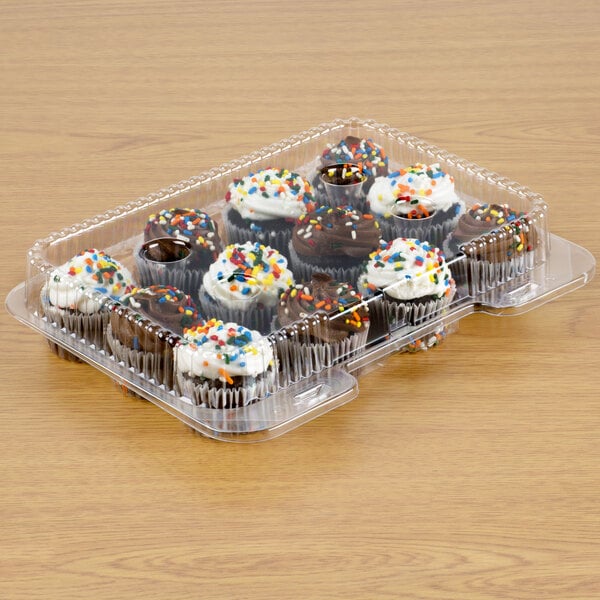 A Polar Pak plastic container holding cupcakes with white frosting and sprinkles.
