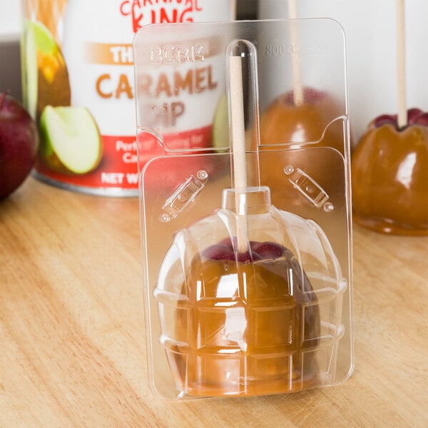 A large plastic container for candy apples.