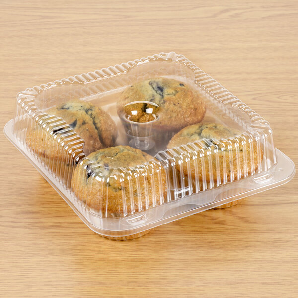 A Polar Pak plastic container with 4 muffins in it.