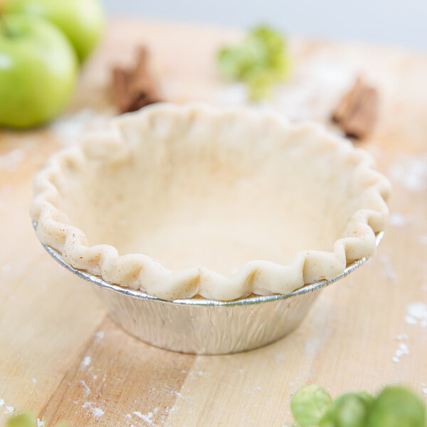 A pie crust in a Baker's Mark foil pie tin.