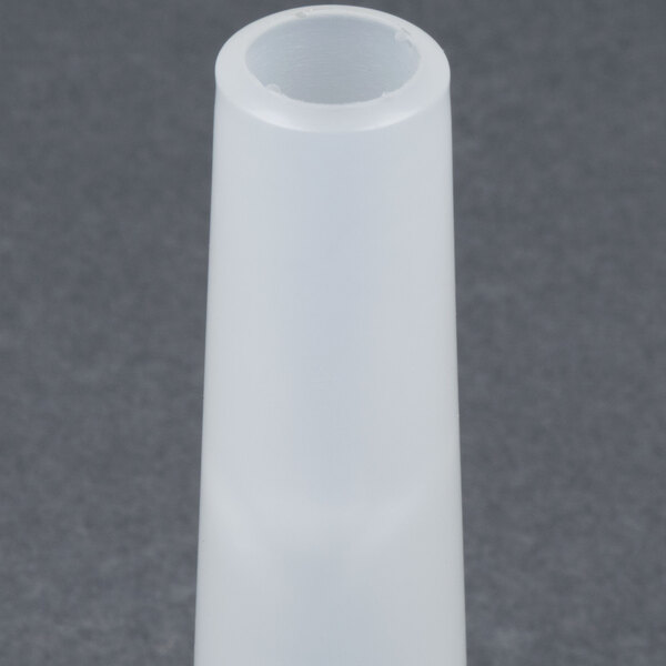 A white plastic cone with a small hole in it.