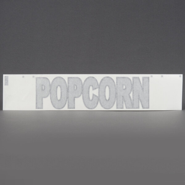A white rectangular object with black text that says "popcorn" on it.