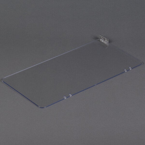 A clear plastic plate with a metal holder.