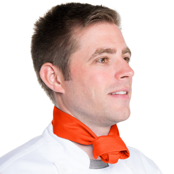 A man wearing an orange Intedge chef neckerchief around his neck.