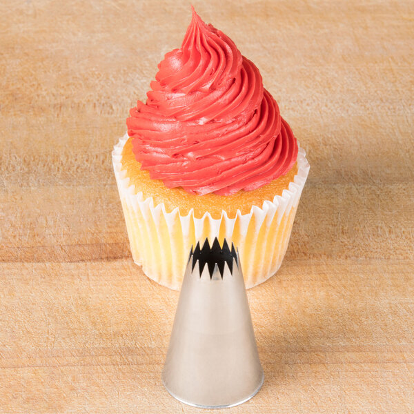 A cupcake with pink frosting on top piped with an Ateco French star nozzle.