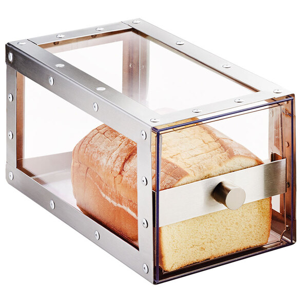 A Cal-Mil stainless steel loaf bread display with a loaf of bread inside on a white surface.