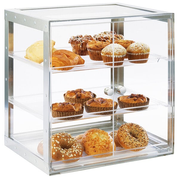 A Cal-Mil stainless steel bakery display case filled with muffins, bagels, and pastries.