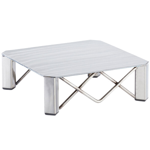 A silver square table with a metal Cal-Mil Industrial Square Riser on top.