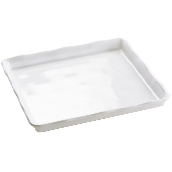 A white rectangular Cal-Mil bakery tray with a wavy edge.