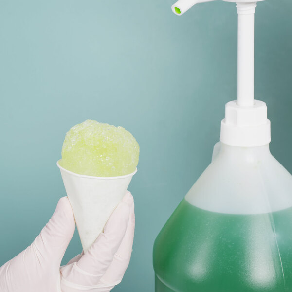 A gloved hand holding a Bare by Solo white paper cone filled with a green liquid.