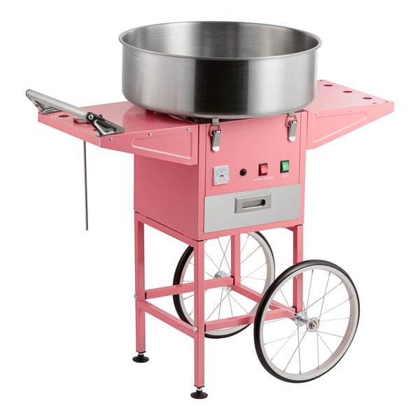 A pink cotton candy machine with a large stainless steel bowl and a wheeled cart.