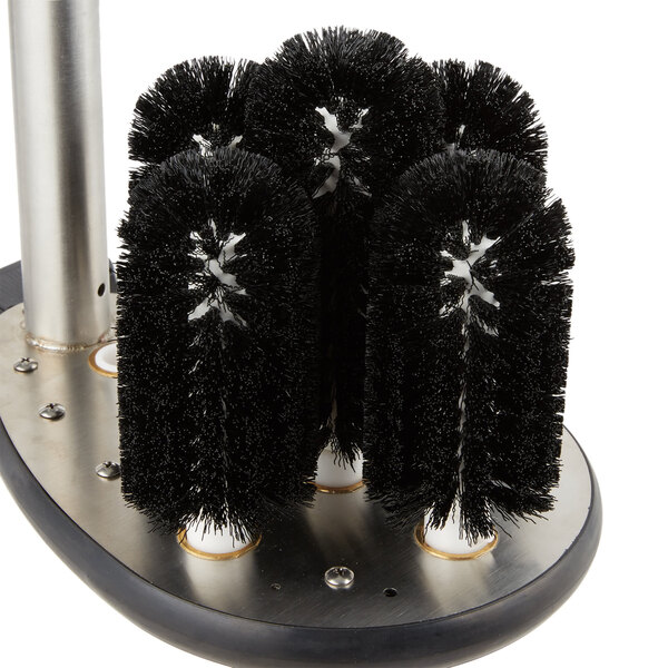A circular black brush with black bristles.