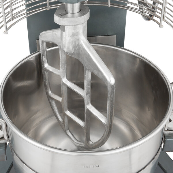 A close-up of an Avantco cast aluminum flat beater in a metal bowl on a mixer.