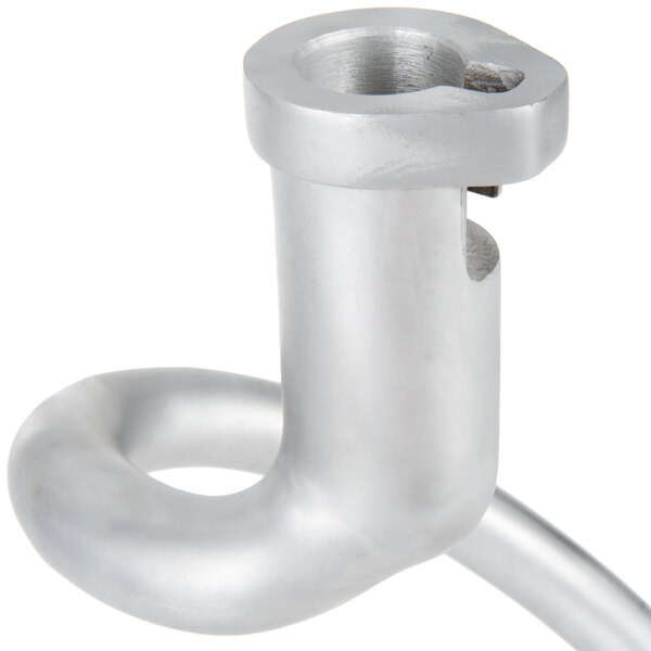 A close up of a silver metal dough hook with a metal handle.