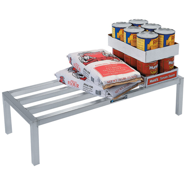 A Lakeside aluminum dunnage rack with food, cans, and bread on it.