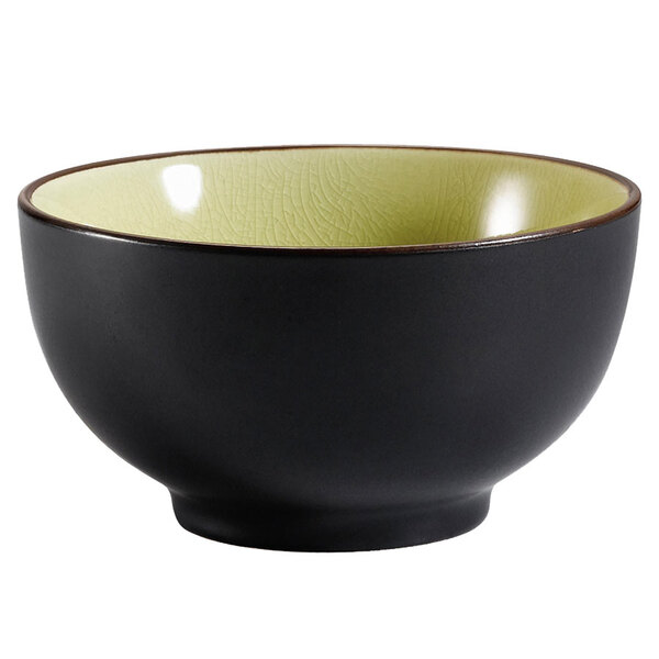 A black CAC Japanese style rice bowl with a yellow interior.