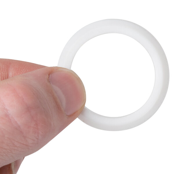 A person holding a white inner roller bearing for an Avantco hot dog roller grill.