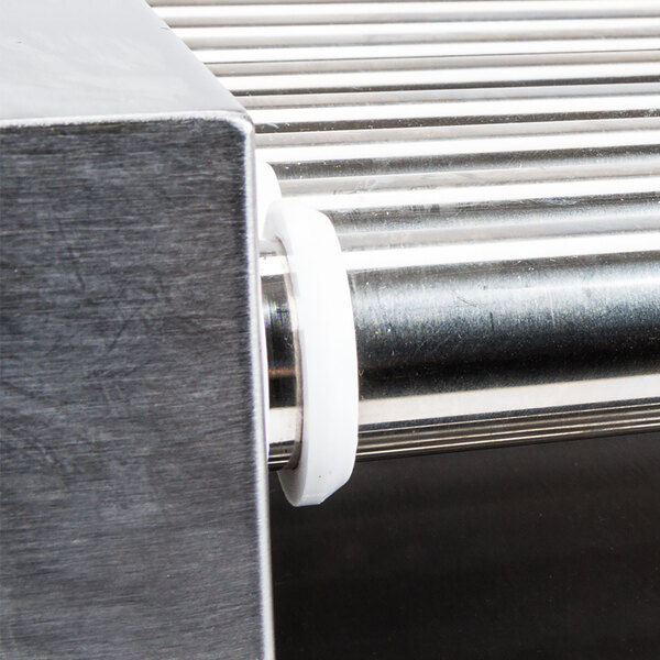 A metal roller bearing with white rubber on it.