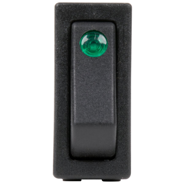 A close-up of a black Avantco lighted on/off rocker switch with a green light.