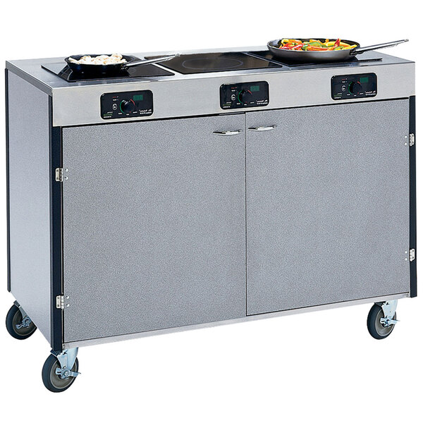 A Lakeside stainless steel cooking cart with 3 induction burners.