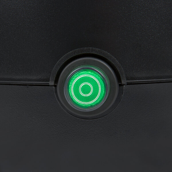 A green button on a black Avantco power switch.