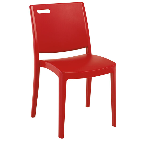 A pack of four red Grosfillex Metro stacking chairs.