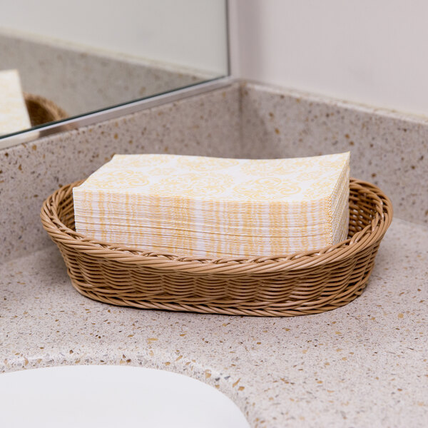 A white basket of Lavex Linen-Feel Elite paper guest towels on a counter.