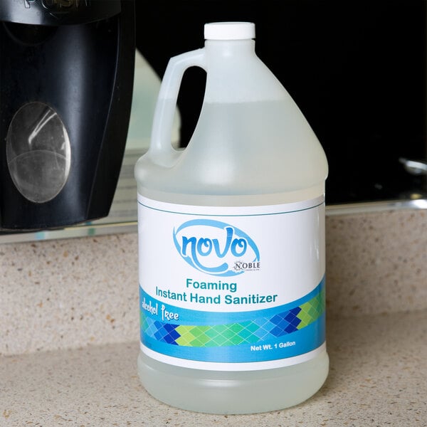 A Noble Chemical Novo gallon bottle of foaming hand sanitizer on a counter.
