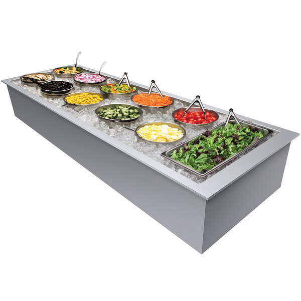 A Hatco drop-in ice-cooled food well holding six pans of salad on a counter in a salad bar.