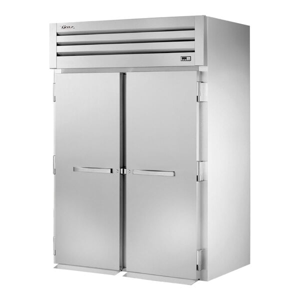A large silver True Spec Series roll-in refrigerator with two solid doors.