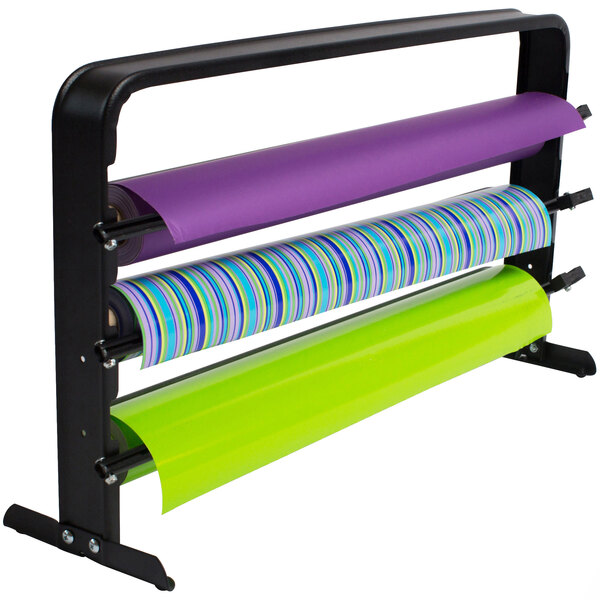 A multi colored wrapping paper on a black Bulman countertop rack with three rolls.
