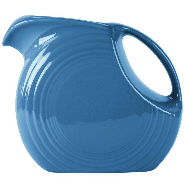 A blue Fiesta Disc China Pitcher with a handle.