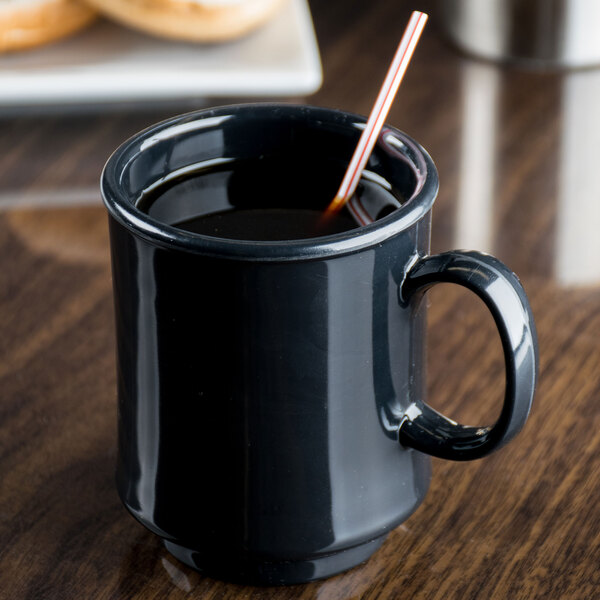 A black GET Tritan mug with a straw in it.