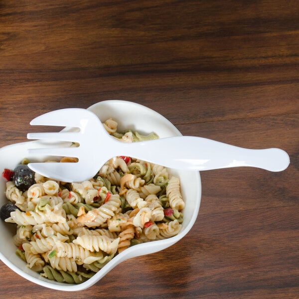 A bowl of pasta with a Fineline white plastic serving fork.