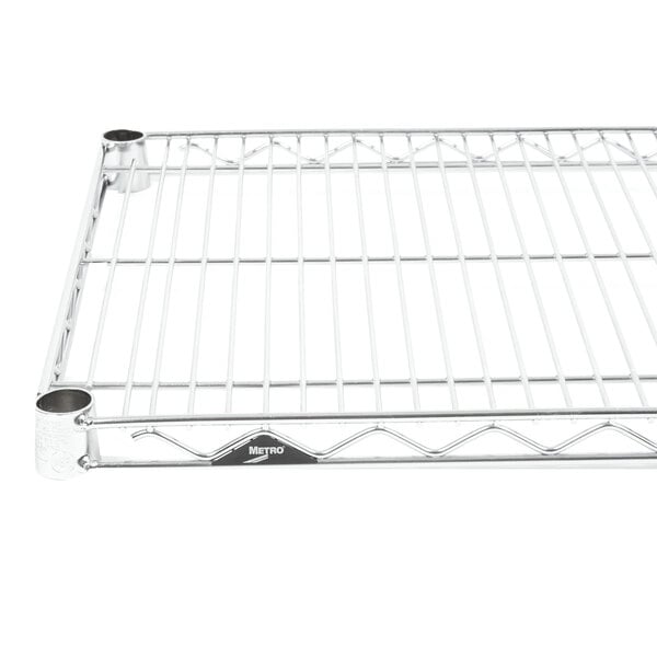 A stainless steel Metro Super Erecta wire shelf with two holes in the base.