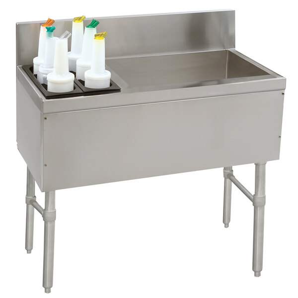 A stainless steel Advance Tabco ice bin and bottle storage combo unit with a bottle holder.