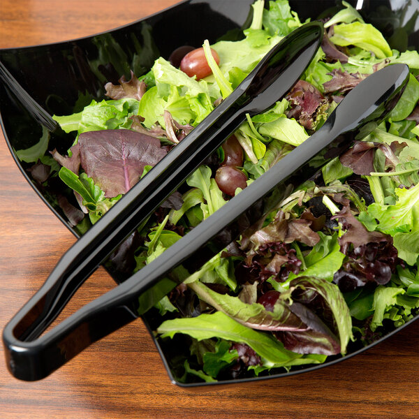 Fineline black plastic tongs serving salad in a bowl.
