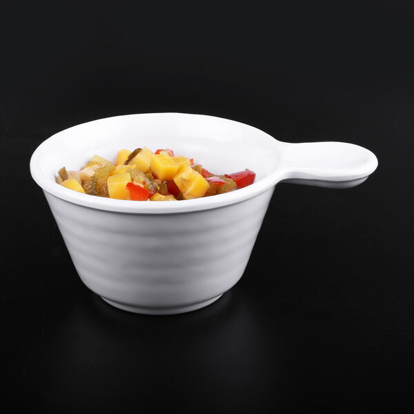 A white Elite Global Solutions Pebble Creek handled bowl with fruit inside.