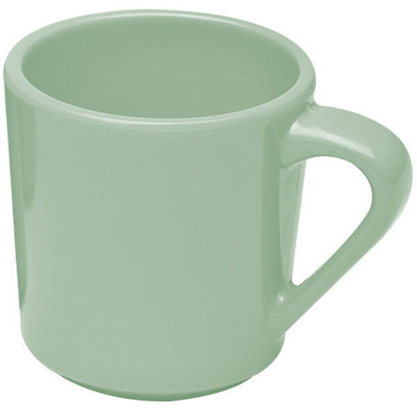 A close-up of a green mug with a handle.