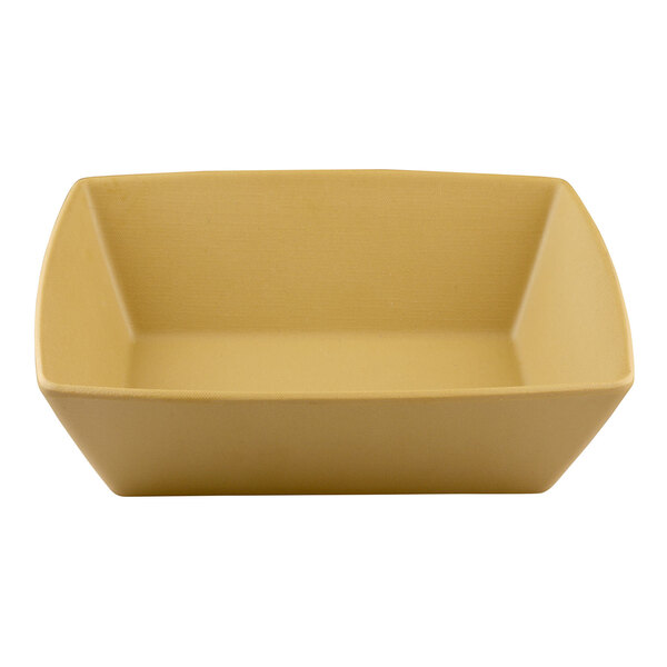 A tan rectangular melamine bowl with a curved edge.